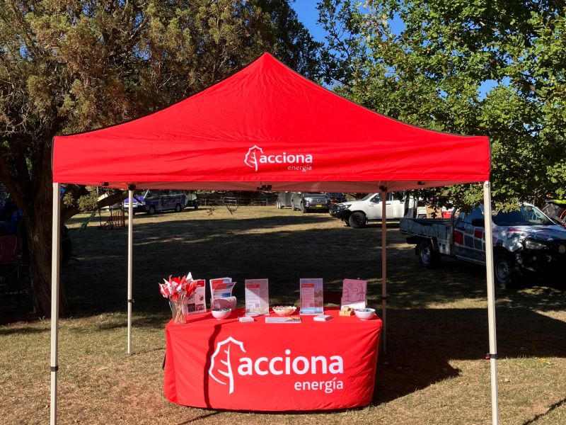 A red tent with a table with a red tablecloth. 