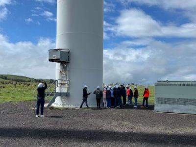 Students and staff walking under a turbine to check out the base