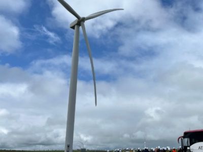 Students under a wind turbine